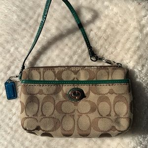 Signature Coach Wristlet with Green Accent Leather